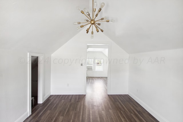 bonus room featuring lofted ceiling, dark hardwood / wood-style flooring, and a notable chandelier