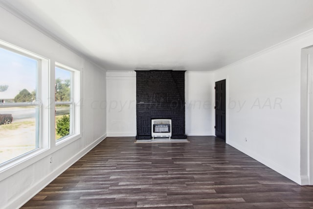 unfurnished living room with heating unit, plenty of natural light, and dark hardwood / wood-style flooring