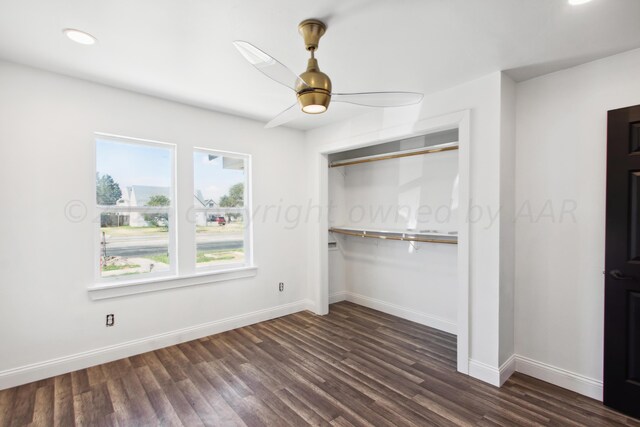 unfurnished bedroom featuring ceiling fan, a closet, and dark hardwood / wood-style flooring