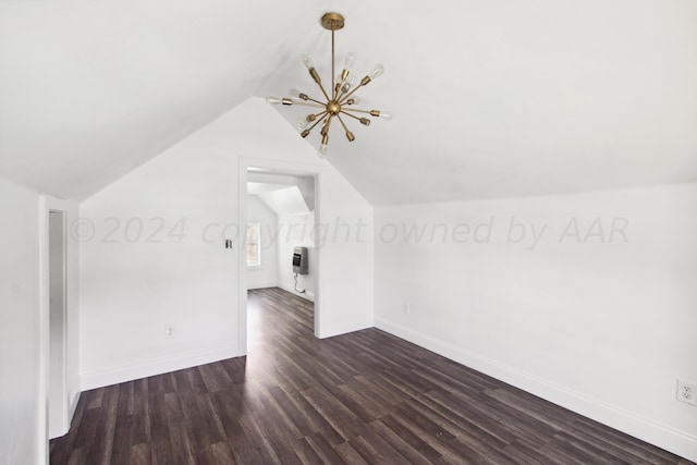 additional living space with heating unit, dark wood-type flooring, lofted ceiling, and an inviting chandelier