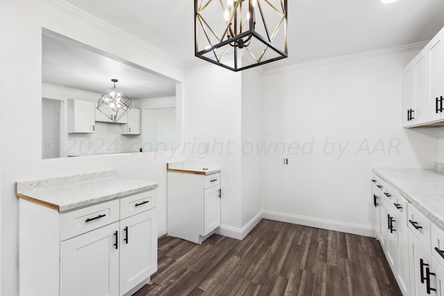 kitchen with ornamental molding, dark hardwood / wood-style flooring, pendant lighting, white cabinets, and a chandelier