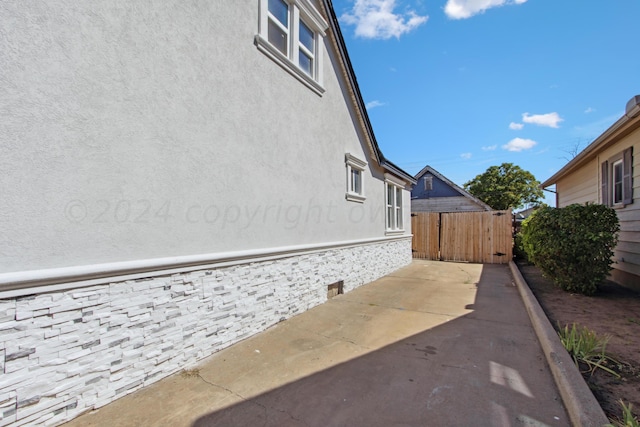 view of side of home featuring a patio area