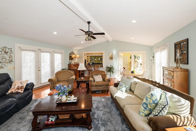 living area with wood finished floors and a ceiling fan