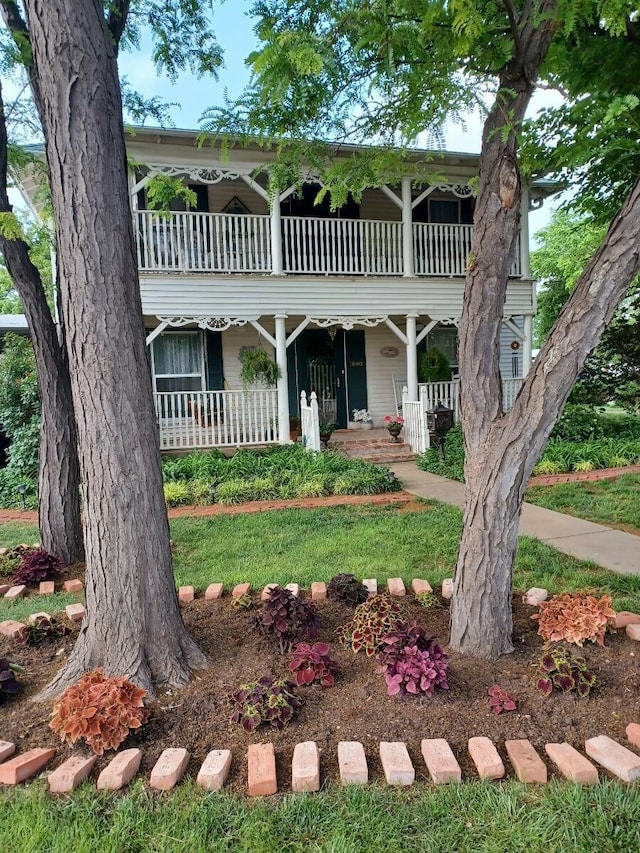 view of front of property with a balcony and covered porch