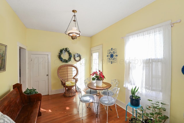 dining room featuring wood finished floors and baseboards