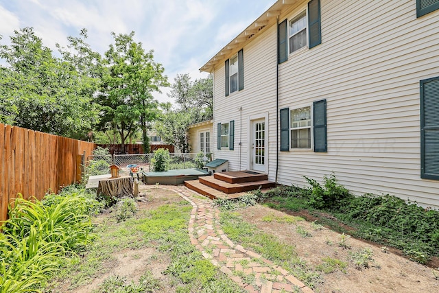 fenced backyard featuring a deck
