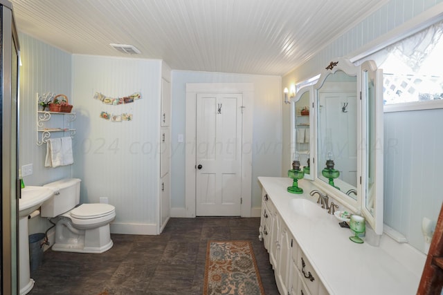 full bathroom with toilet, vanity, and baseboards