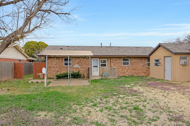 back of house featuring a patio area, brick siding, and a shingled roof
