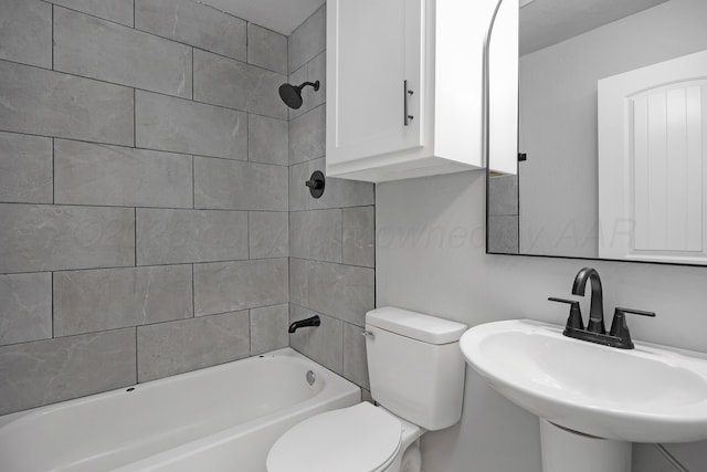 bathroom with a sink, toilet, and  shower combination