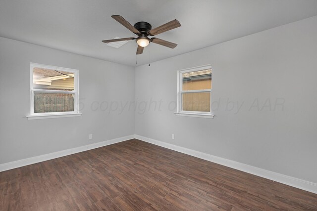 empty room with dark wood-type flooring, baseboards, and a ceiling fan