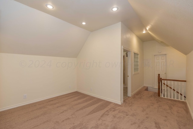 bonus room featuring recessed lighting, lofted ceiling, carpet floors, and baseboards