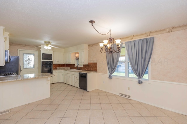 kitchen featuring black appliances, white cabinetry, a sink, and visible vents
