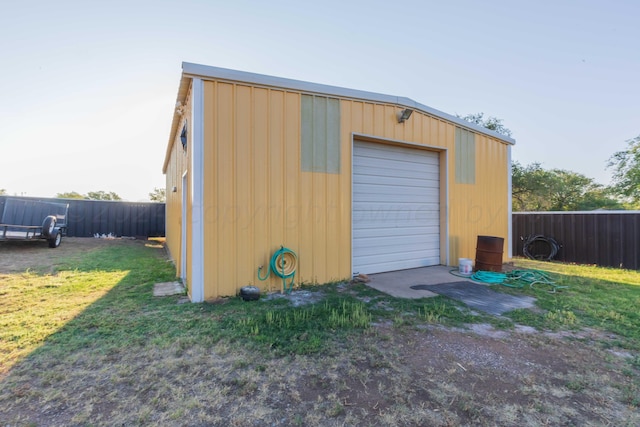 view of outbuilding featuring fence and an outbuilding