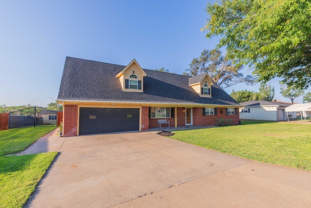 cape cod home with brick siding, a front lawn, a garage, and fence