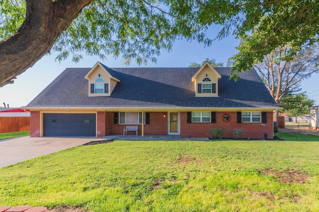 view of front of home featuring a garage, driveway, fence, a front yard, and brick siding
