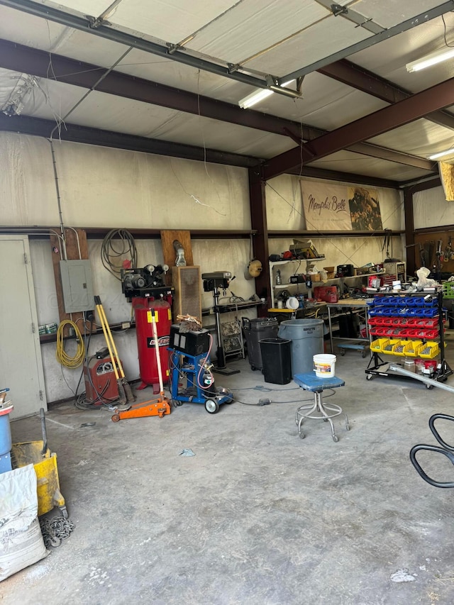 garage featuring electric panel and a workshop area