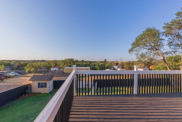 wooden deck featuring a fenced backyard and a yard