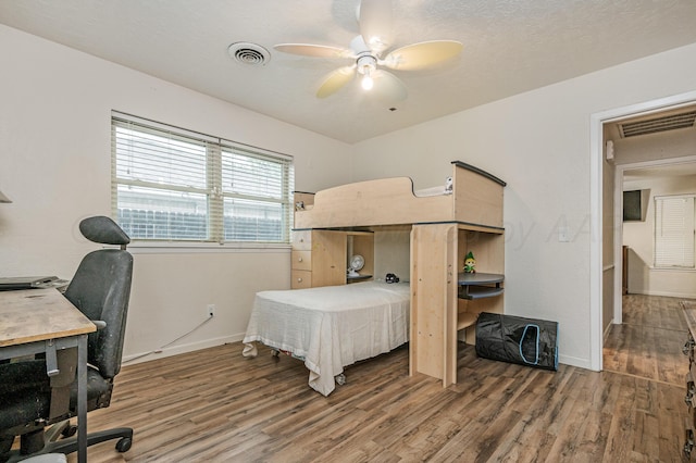 7216 Gainsborough Rd, Amarillo, TX 79106 - bedroom featuring wood finished floors, baseboards, a desk, and a ceiling fan