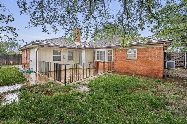 7216 Gainsborough Rd, Amarillo, TX 79106 - back of property with central air condition unit, a fenced backyard, a chimney, and a patio area