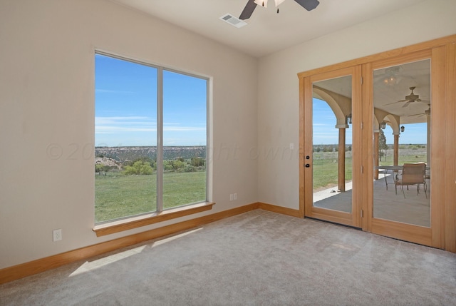 unfurnished room with ceiling fan, a healthy amount of sunlight, and carpet floors