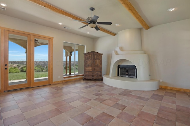 unfurnished living room featuring beamed ceiling, ceiling fan, light tile patterned flooring, and a fireplace