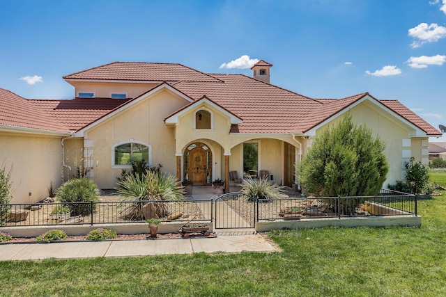 mediterranean / spanish house featuring a front yard