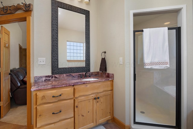 bathroom with vanity and a shower with shower door