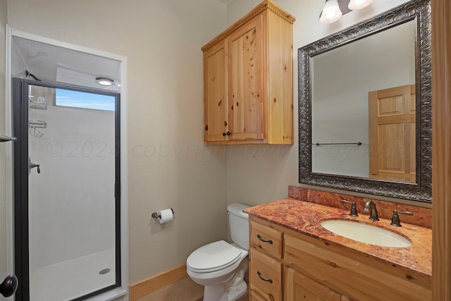 bathroom featuring tile patterned flooring, vanity, toilet, and a shower with door