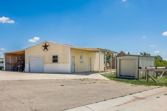 view of front of home featuring an outbuilding, a garage, and a carport