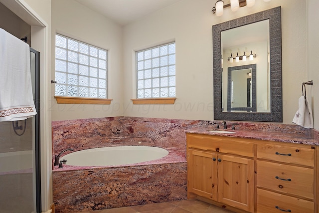 bathroom featuring tile patterned floors, a wealth of natural light, vanity, and independent shower and bath