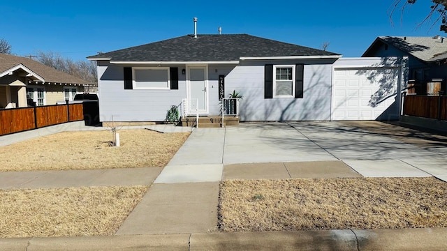 view of front of property with a shingled roof and fence