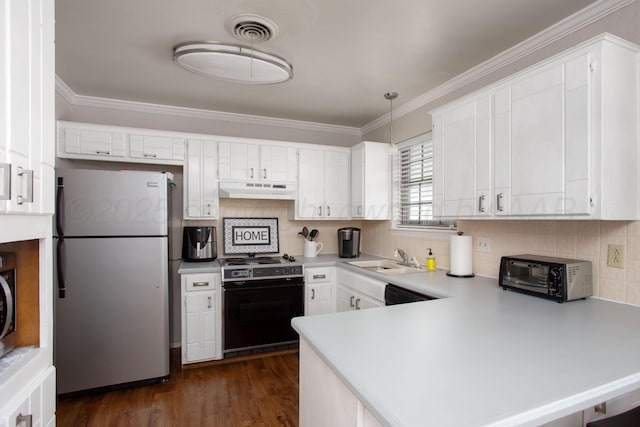 5701 Durrett Pl, Amarillo, TX 79109 - kitchen featuring freestanding refrigerator, stove, under cabinet range hood, a peninsula, and light countertops