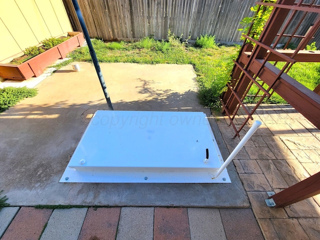 view of storm shelter featuring fence