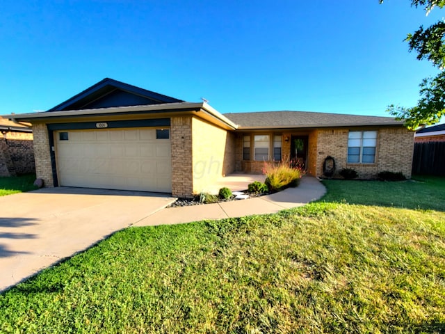 ranch-style house featuring brick siding, a front yard, concrete driveway, and an attached garage