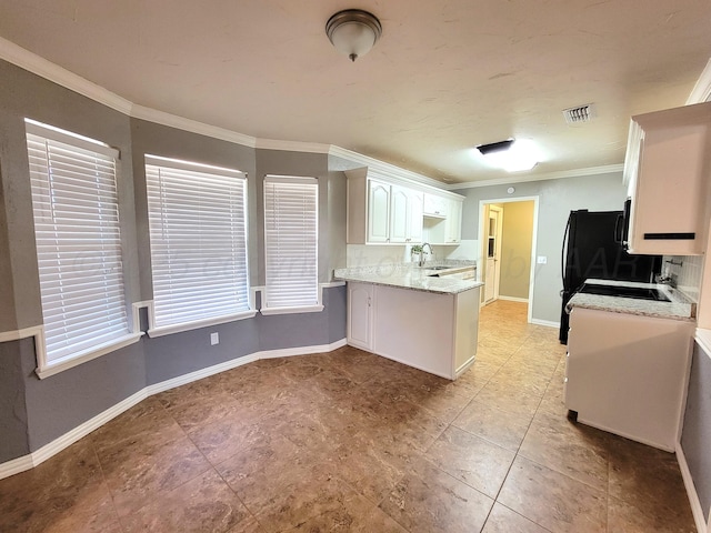 kitchen with crown molding, baseboards, a peninsula, white cabinetry, and a sink