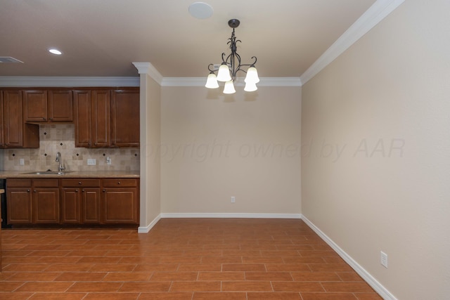 7111 Mosley St, Amarillo, TX 79119 - kitchen featuring light countertops, a chandelier, baseboards, backsplash, and ornamental molding