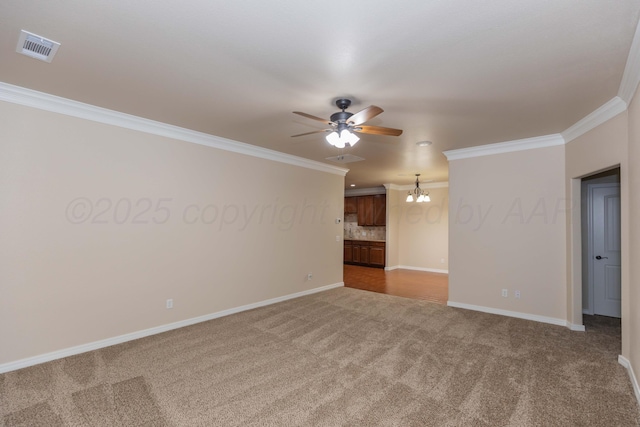 7111 Mosley St, Amarillo, TX 79119 - carpeted spare room with crown molding, baseboards, visible vents, and ceiling fan with notable chandelier