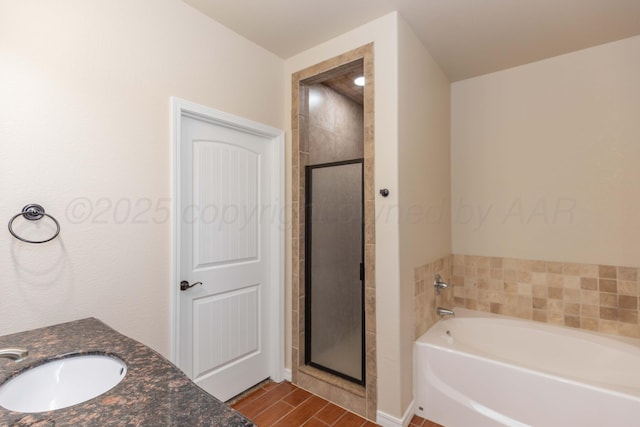 7111 Mosley St, Amarillo, TX 79119 - bathroom with wood finished floors, a sink, a garden tub, and a stall shower