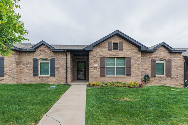 7111 Mosley St, Amarillo, TX 79119 - ranch-style house with brick siding, a shingled roof, and a front yard