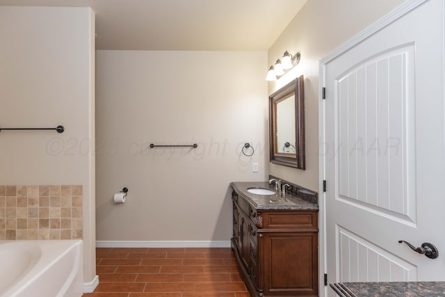 7111 Mosley St, Amarillo, TX 79119 - full bathroom with baseboards, wood finished floors, a garden tub, and vanity