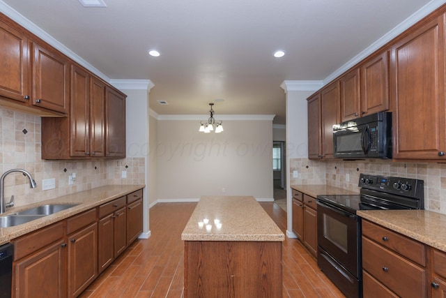 7111 Mosley St, Amarillo, TX 79119 - kitchen with an inviting chandelier, a sink, light wood-style flooring, a center island, and black appliances