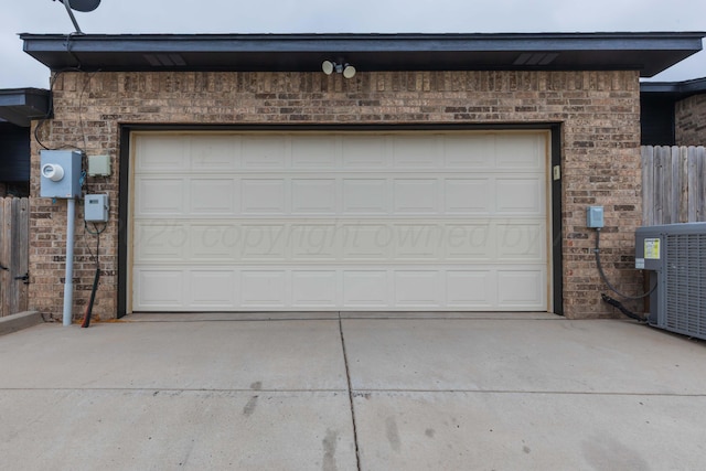 7111 Mosley St, Amarillo, TX 79119 - garage featuring central air condition unit, fence, and concrete driveway