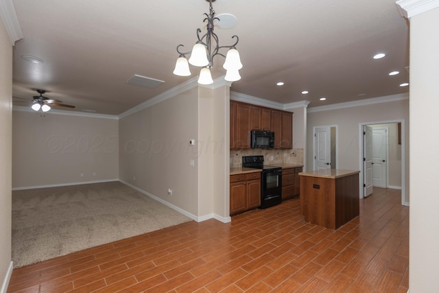 7111 Mosley St, Amarillo, TX 79119 - kitchen featuring crown molding, baseboards, and black appliances