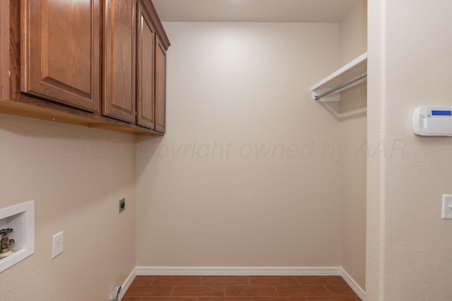 7111 Mosley St, Amarillo, TX 79119 - laundry area with cabinet space, electric dryer hookup, baseboards, and hookup for a washing machine
