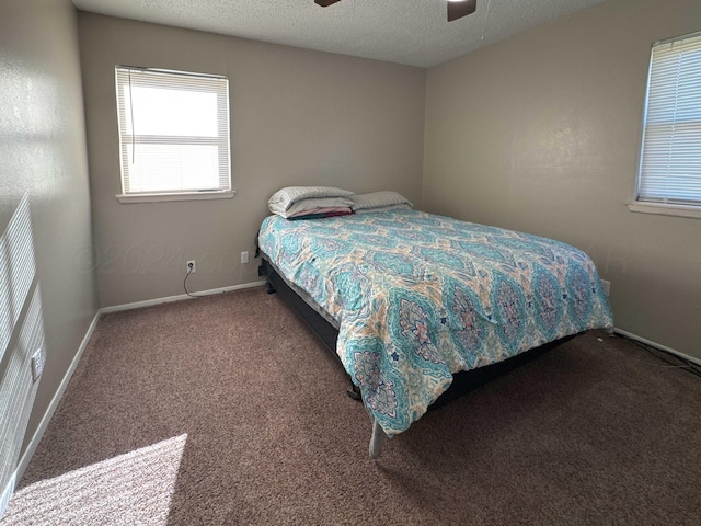 bedroom with carpet flooring, ceiling fan, and a textured ceiling