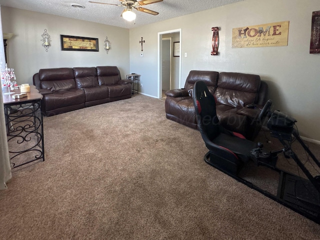 living room featuring ceiling fan, carpet floors, and a textured ceiling