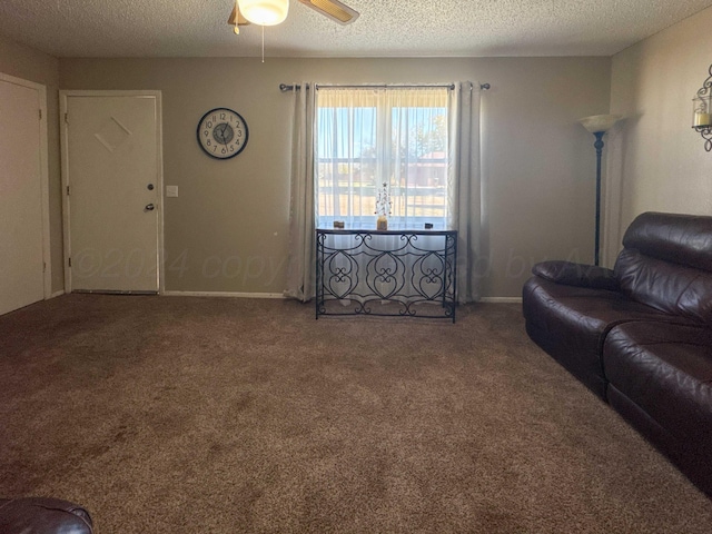 carpeted living room with a textured ceiling and ceiling fan