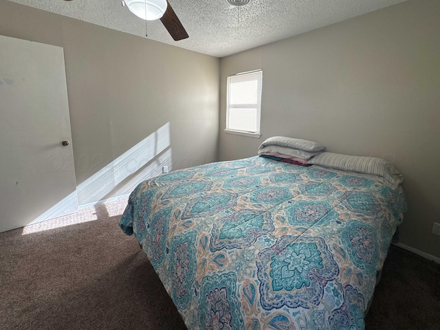 bedroom with carpet flooring, ceiling fan, and a textured ceiling