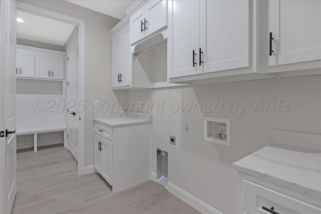 5805 Sheridan St, Amarillo, TX 79119 - washroom featuring cabinet space, light wood finished floors, electric dryer hookup, washer hookup, and baseboards