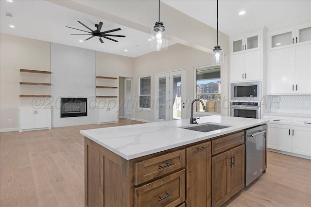 5805 Sheridan St, Amarillo, TX 79119 - kitchen with a sink, appliances with stainless steel finishes, open floor plan, light wood-type flooring, and ceiling fan